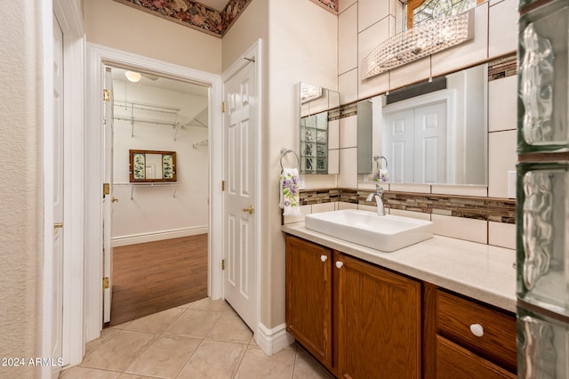 bathroom featuring tasteful backsplash, large vanity, and hardwood / wood-style flooring