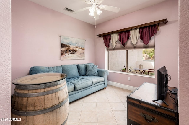 tiled living room featuring ceiling fan