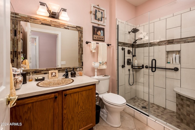 bathroom featuring walk in shower, toilet, tile floors, and vanity with extensive cabinet space