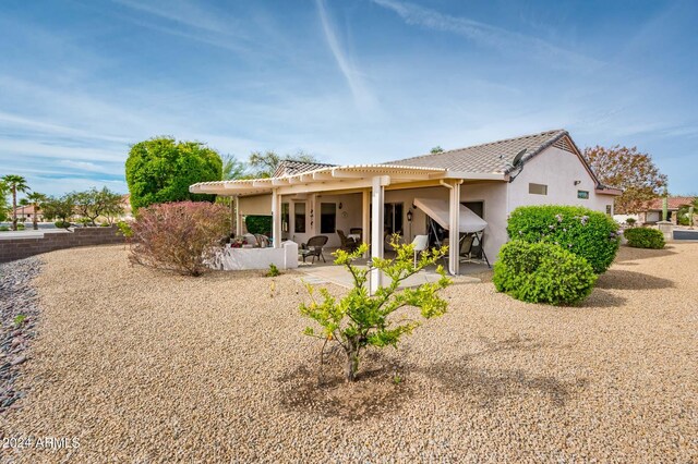 back of property featuring a patio