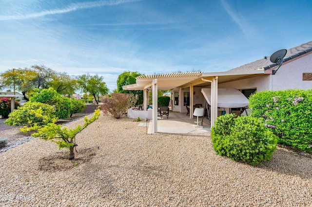 back of house with a pergola and a patio area