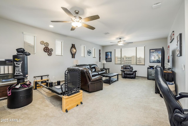 living area with recessed lighting, a healthy amount of sunlight, visible vents, and light carpet