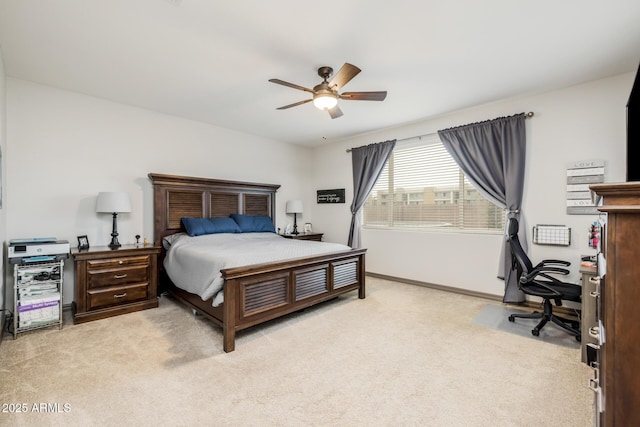 bedroom featuring a ceiling fan, baseboards, and light carpet