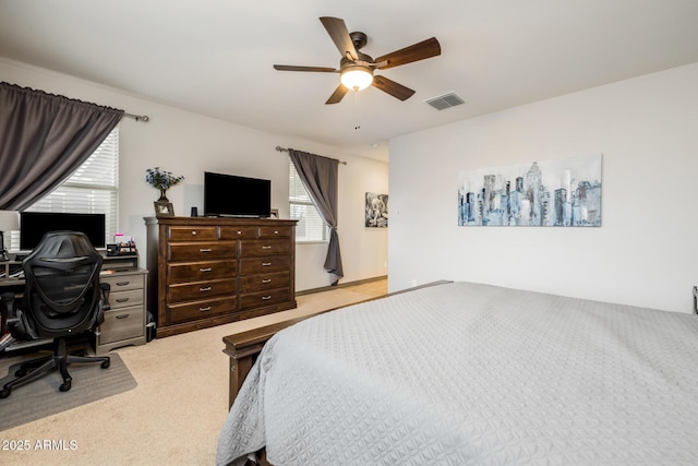 bedroom featuring a ceiling fan, visible vents, and carpet floors