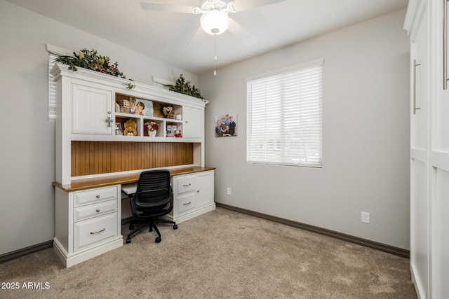 home office with light colored carpet, baseboards, and ceiling fan