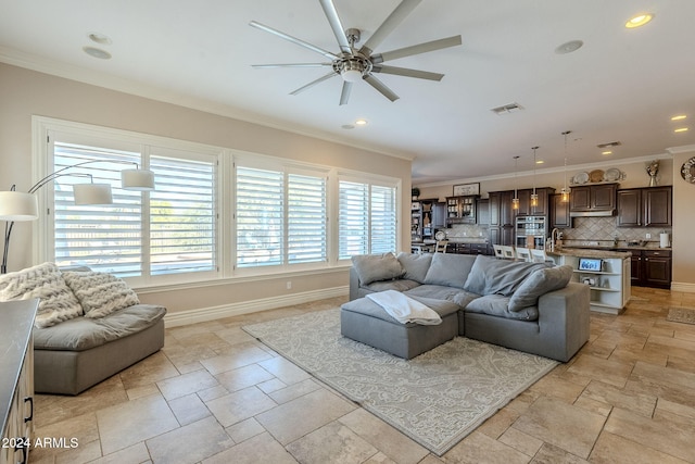 living room with ceiling fan and crown molding