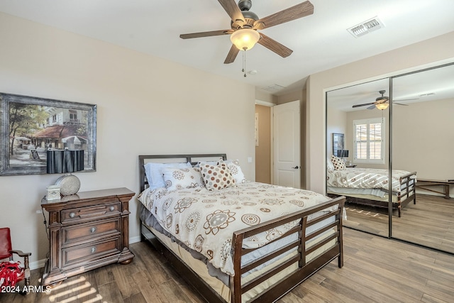 bedroom featuring hardwood / wood-style flooring, ceiling fan, and a closet