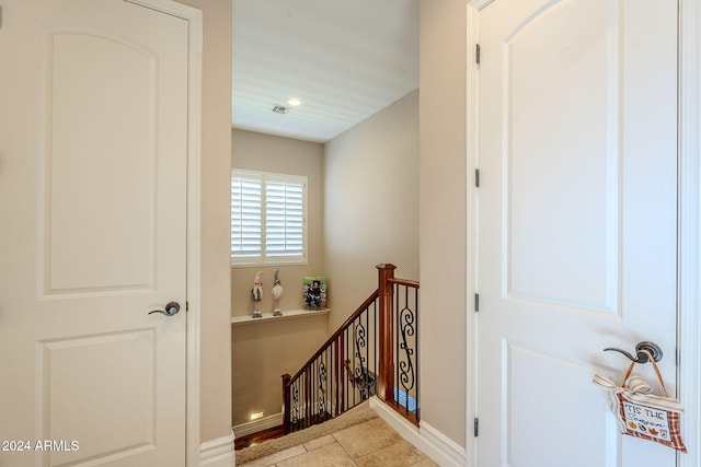 hall with light tile patterned floors