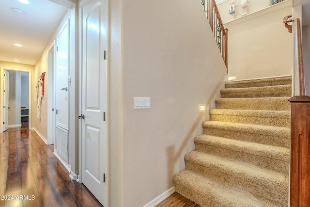 stairs featuring hardwood / wood-style flooring