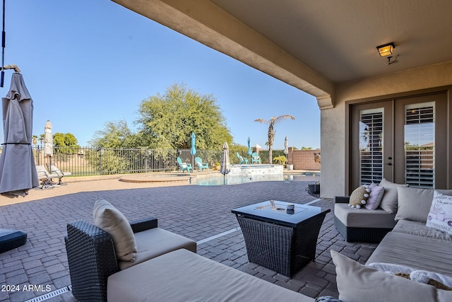 view of patio featuring a swimming pool with hot tub and an outdoor hangout area