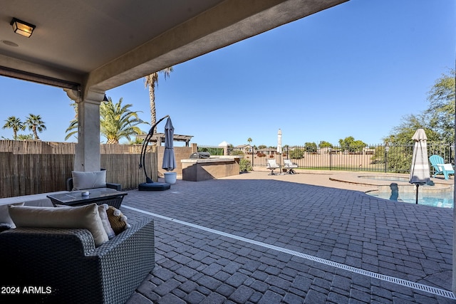 view of patio / terrace featuring a pool with hot tub and area for grilling