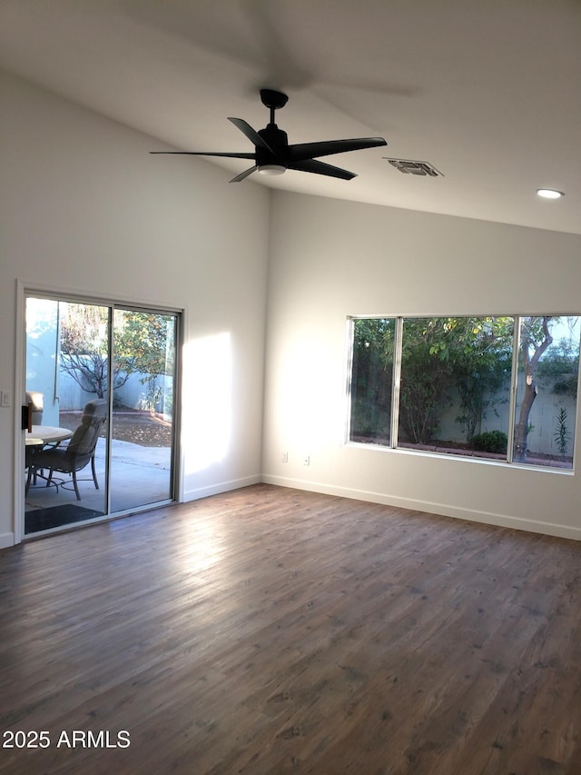 unfurnished room with ceiling fan and dark hardwood / wood-style floors