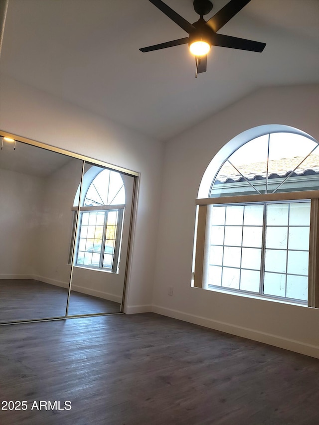 unfurnished room with ceiling fan and dark hardwood / wood-style flooring