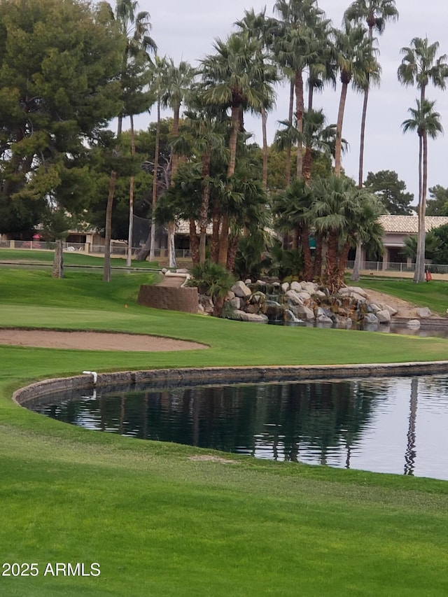 view of home's community featuring a water view and a yard