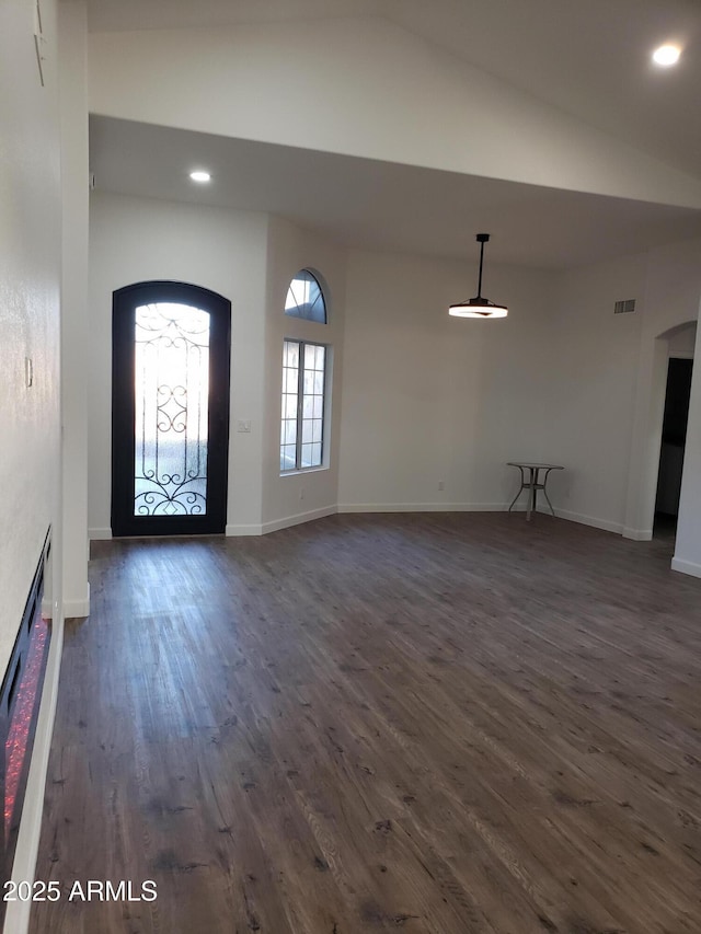 foyer featuring vaulted ceiling and dark hardwood / wood-style floors