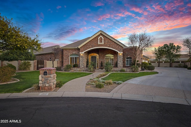 view of front of house featuring driveway, an attached garage, fence, and a front yard