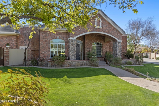 view of front facade with a front lawn and brick siding