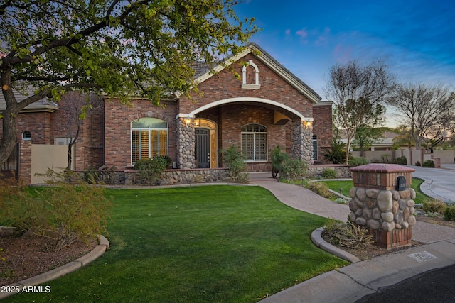 traditional-style house featuring a front lawn and brick siding