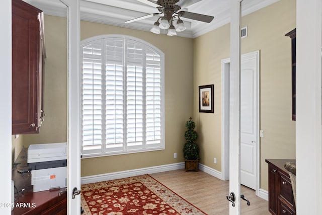 office space featuring a ceiling fan, visible vents, light wood-style flooring, and baseboards