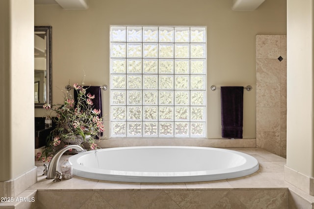 bathroom with plenty of natural light and a bath