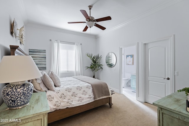 bedroom featuring crown molding, ensuite bathroom, light carpet, ceiling fan, and baseboards