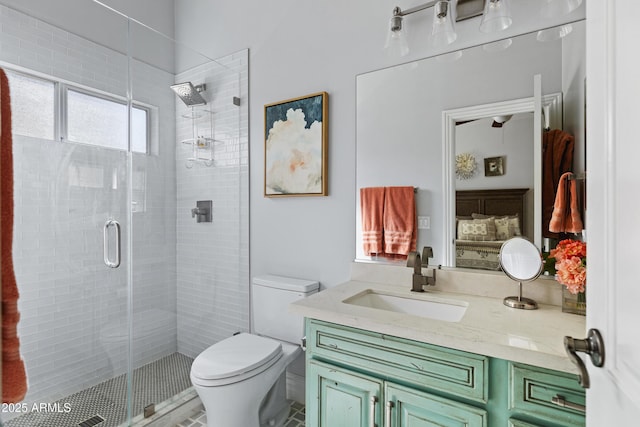 bathroom featuring a stall shower, vanity, and toilet