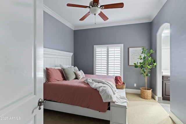 bedroom featuring ornamental molding, light carpet, ceiling fan, and baseboards