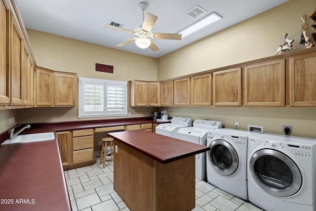 laundry area with cabinet space, visible vents, washing machine and dryer, a sink, and ceiling fan