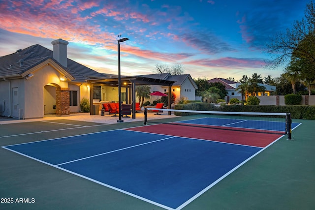 view of tennis court featuring fence