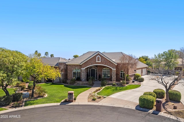 view of front of home with a tile roof, brick siding, concrete driveway, an attached garage, and a front lawn