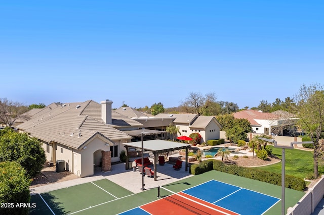 exterior space with a patio, basketball hoop, a gazebo, fence, and a residential view