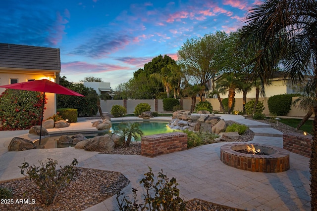 view of swimming pool with a fenced in pool, a patio area, a fire pit, and a fenced backyard