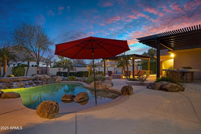 view of pool featuring outdoor dry bar, a patio area, an outdoor kitchen, and a pergola