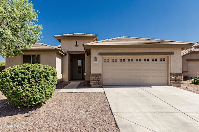 15429 W Ventura St, Surprise, AZ 85379 - view of front of property with a garage, concrete driveway, stucco siding, and stone siding