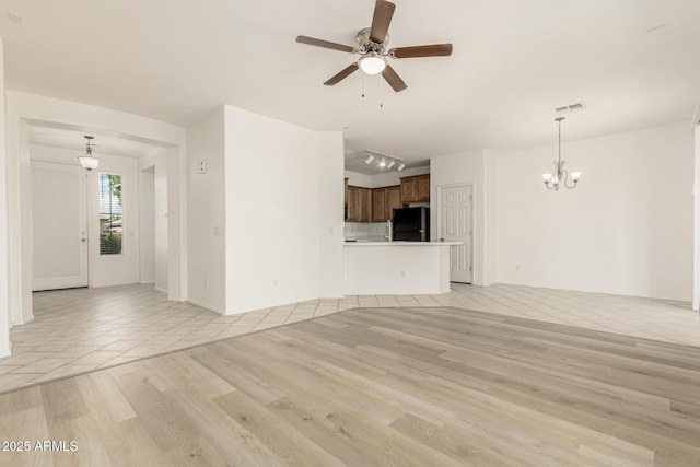 15429 W Ventura St, Surprise, AZ 85379 - unfurnished living room featuring a chandelier, light wood-type flooring, and ceiling fan