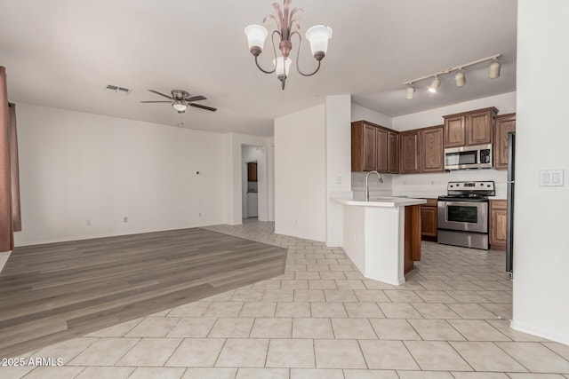 15429 W Ventura St, Surprise, AZ 85379 - kitchen with appliances with stainless steel finishes, open floor plan, light countertops, ceiling fan, and a peninsula