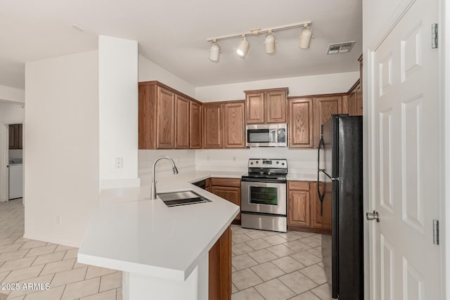 15429 W Ventura St, Surprise, AZ 85379 - kitchen with appliances with stainless steel finishes, a peninsula, light tile patterned floors, and light countertops