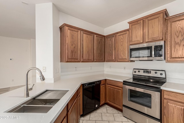 15429 W Ventura St, Surprise, AZ 85379 - kitchen featuring stainless steel appliances, brown cabinetry, and light countertops