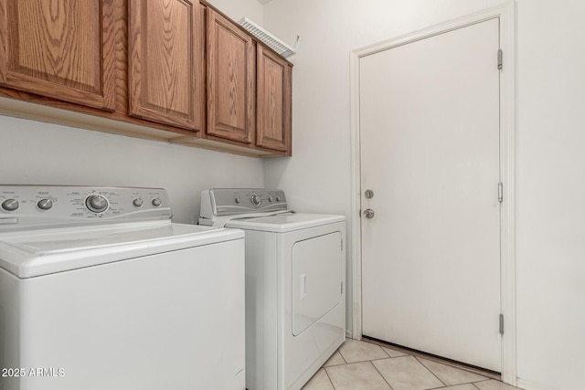 15429 W Ventura St, Surprise, AZ 85379 - laundry room with washer and clothes dryer, cabinet space, and light tile patterned floors