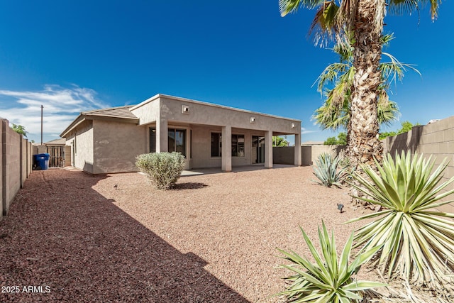 15429 W Ventura St, Surprise, AZ 85379 - back of property with stucco siding, a fenced backyard, and a patio