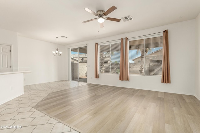 15429 W Ventura St, Surprise, AZ 85379 - empty room featuring a chandelier, ceiling fan, and light wood-style floors