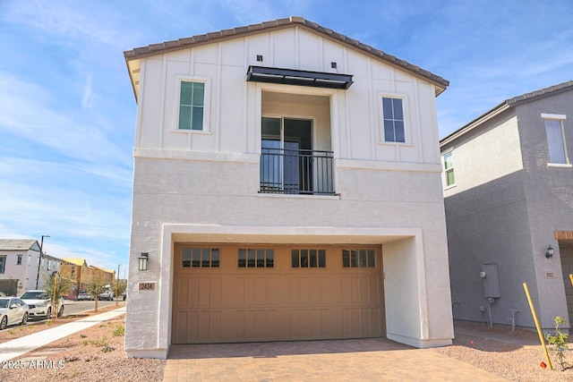 modern farmhouse featuring a garage, decorative driveway, and board and batten siding