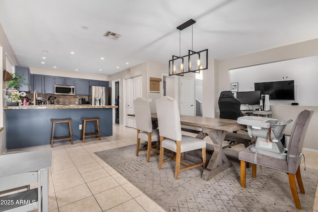 dining space featuring light tile patterned floors, visible vents, an inviting chandelier, and recessed lighting