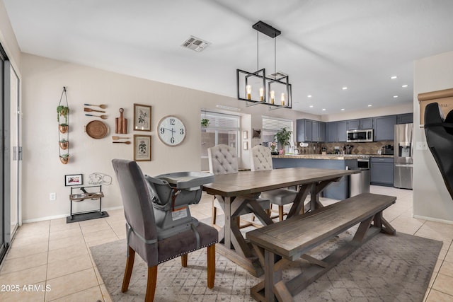 dining area featuring visible vents, recessed lighting, an inviting chandelier, light tile patterned flooring, and baseboards