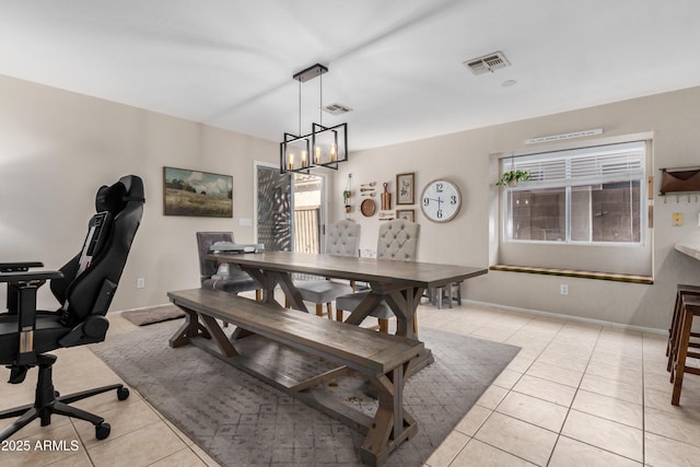 dining space with a notable chandelier, light tile patterned flooring, baseboards, and visible vents