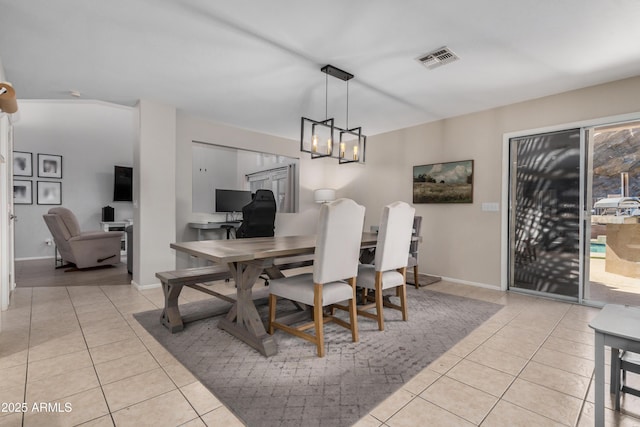 tiled dining area featuring visible vents, baseboards, and a notable chandelier