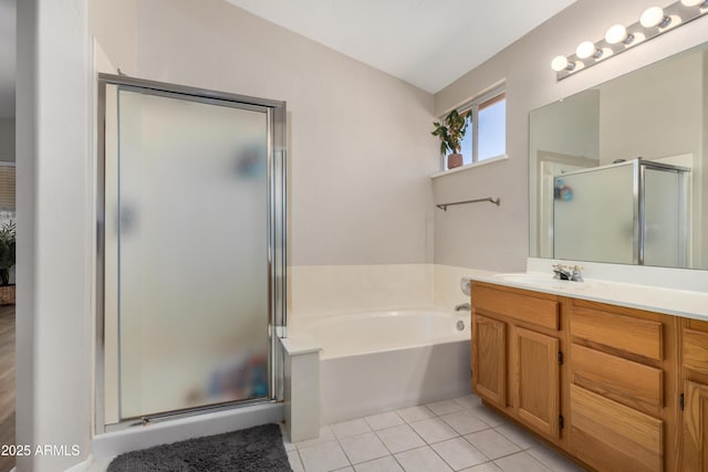 bathroom featuring a bath, a stall shower, vanity, and tile patterned flooring