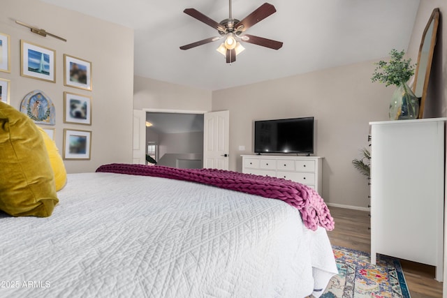 bedroom featuring a ceiling fan, baseboards, and wood finished floors