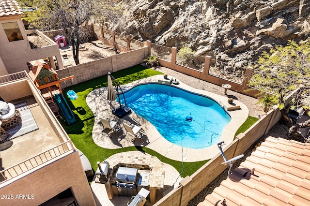 view of swimming pool with a fenced in pool, a fenced backyard, and a patio area