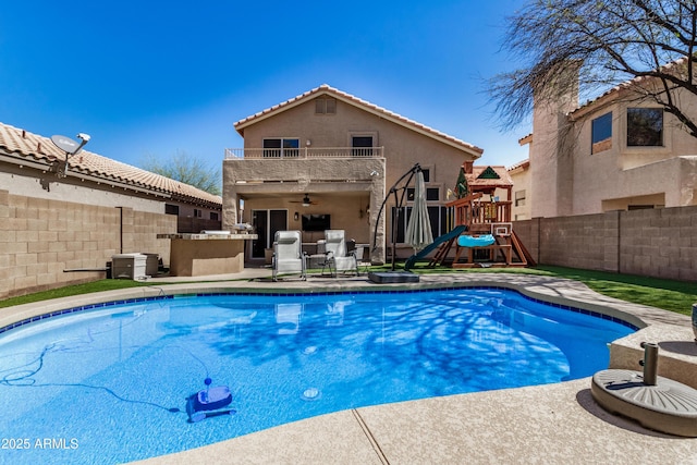 view of swimming pool with a fenced in pool, a patio, a playground, and a fenced backyard